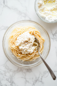white-marble-lasagna-noodle-spread-with-cheese-spinach-mushroom-filling-glass-bowl