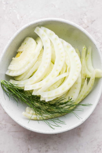 Start by thinly slicing the fennel bulb