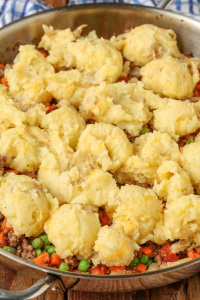 Spread the mashed potatoes over the beef filling